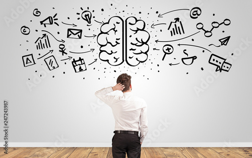Fotografía Angry manager looking to wall with drawn overloaded brain concept