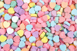 Background of brightly colored candy hearts for Valentine's Day.