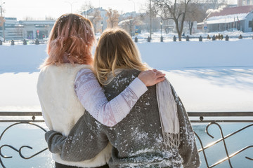 Wall Mural - Two women hugging by the river