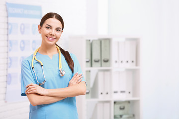 Wall Mural - Portrait of medical assistant with stethoscope in hospital. Space for text