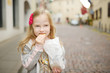 © MNStudio - Adorable little girl eating fresh baked cookies on warm and sunny summer day
