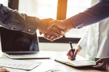two businessmen handshaking in meeting after final project agreement deal done.