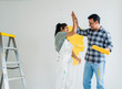 © Rawpixel.com - Couple giving a high five while renovating their new house