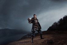 Medieval Knight With Sword And Spear In Ancient Armour Over Winter Landscapes