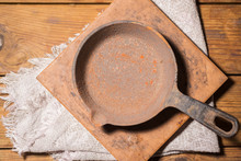 Old Empty Cast Iron Pan. Rusty Dishes