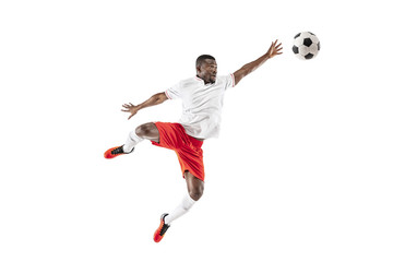 Wall Mural - Professional african american football soccer player in motion isolated on white studio background. Fit jumping man in action, jump, movement at game.