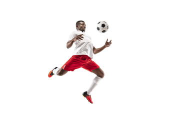 Wall Mural - Professional african american football soccer player in motion isolated on white studio background. Fit jumping man in action, jump, movement at game.