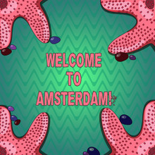 Handwriting Text Writing Welcome To Amsterdam. Concept Meaning Greeting Someone Visits The Capital City Of Netherlands Starfish Photo On Four Corners With Colorful Pebbles For Poster Ads Cards