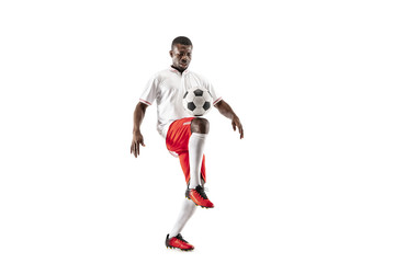 Professional african american football soccer player in motion isolated on white studio background. Fit jumping man in action, jump, movement at game.