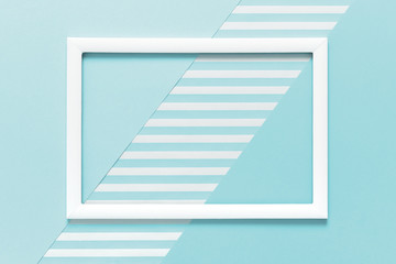 Wall Mural - Abstract geometrical baby pastel blue flat lay background. Minimalism, geometry and symmetry template with empty picture frame mock up.