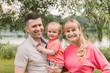 © Илона Удалова - Family walk in the park. Family walks in the park. Man, woman and child in nature.