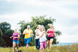 © Kzenon - Family running on a meadow with flowers for sport