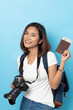 © suriya - Traveler tourist Asian women holding passport with camera isolated on blue background , Travel Holiday Concept