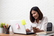 © suriya - Asian young Businesswoman working laptop computer on wood desk in Home office