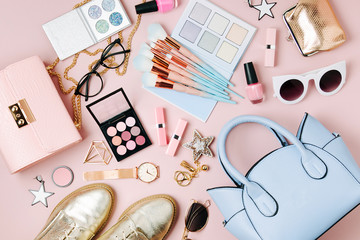flat lay of female fashion accessories, makeup products and handbag on pastel color background. beau