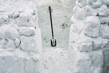 Building Of A Snow House From Snow Bricks Using A Spade