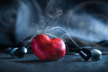 Smoking Red Heart With Earphones On A Blue Smoky Background