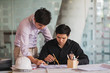 © Songsak C - Image of engineer meeting for architectural project working with partner and engineering tools on workplace.
