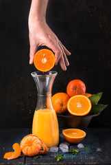 Sticker - glass of fresh orange juice with fresh fruits on wooden