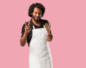 Handsome african american baker fun and happy, positive and natural, makes a gesture of victory, peace concept