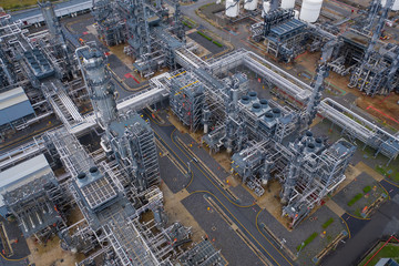 Wall Mural - Industrial top view at oil refinery plant form industry zone ,which factory - petrochemical plant, Shot from drone of Oil refinery.evening scenery.