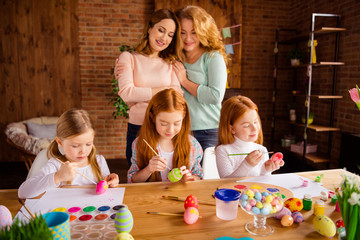 Sticker - Portrait of nice attractive cheerful ladies helping assisting girls doing making decorative things dying eggs youth in house brick loft industrial interior room indoors