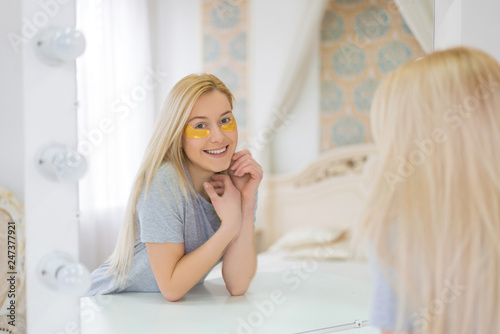 Young Attractive Woman With Long Blonde Hair And Mask Under Eyes