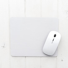 White Wireless Mouse On A Mouse Pad, Top View