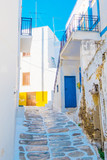 Fototapeta Na drzwi - Narrow street with traditional rustic houses in the village of Lefkes, Island of Paros, Greece