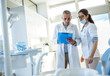 © BalanceFormCreative - Medical dentist team in dental office examining list of patients.