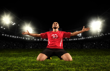 Soccer player on stadium celebrating winner