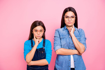 Sticker - Portrait of two nice trendy cute pretty lovely attractive charming suspicious funny curious straight-haired girls touching cheek guessing isolated over pink pastel background