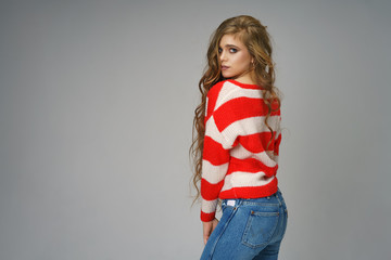 Wall Mural - young beautiful woman posing in Studio on background in jeans, beautiful long hair