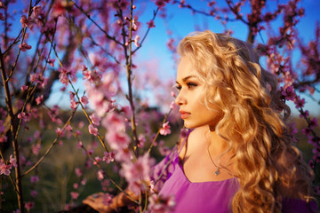 Wall Mural - portrait of beautiful blonde woman in blooming rose garden, spring mood Sunny day