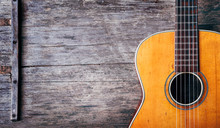 Closeup Of Old Acoustic Spanish Guitar On Rustic Wooden Background From Above.