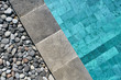 Closeup photo of pool edge which decorated with pebbles
