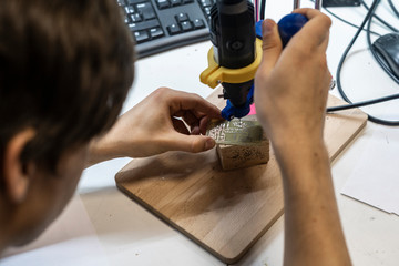 Wall Mural - young male doing holes in electrinic or silicon plate b