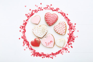 Wall Mural - Valentine day cookies with heart shaped sprinkles on white wooden table