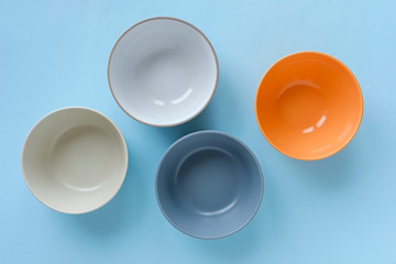 Wall Mural - Assorted empty clean bowls and plates on blue