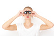 © primipil - Portrait of happy young woman model looking through binoculars. Searching gift concept.