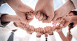 © ASDF - close up. employees of the company forming a circle out of their fists