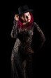 © Tiina Võsumägi - Beautiful woman with red long hair wearing a lacy dress and hat. Beauty portrait of modern fashion, black background.