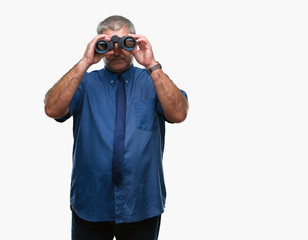 Canvas Print - Handsome senior man looking through binoculars over isolated background with a confident expression on smart face thinking serious