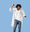© Asier - Handsome african american medical doctor Listening to music, dancing and having fun, moving, shouting and expressing happiness, freedom concept