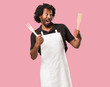 © Asier - Handsome african american baker screaming happy, surprised by an offer or a promotion, gaping, jumping and proud