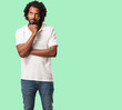 © Asier - Handsome african american doubting and confused, thinking of an idea or worried about something