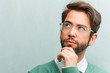 © Asier - Young handsome entrepreneur man face closeup thinking and looking up, confused about an idea, would be trying to find a solution