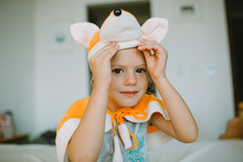 Little Child Girl Dressed In Fox Costume At Home.