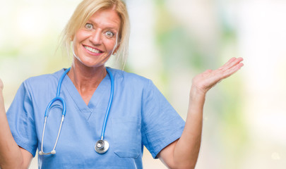 Canvas Print - Middle age blonde nurse surgeon doctor woman over isolated background clueless and confused expression with arms and hands raised. Doubt concept.