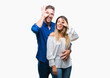 © Krakenimages.com - Young couple in love over isolated background doing ok gesture with hand smiling, eye looking through fingers with happy face.